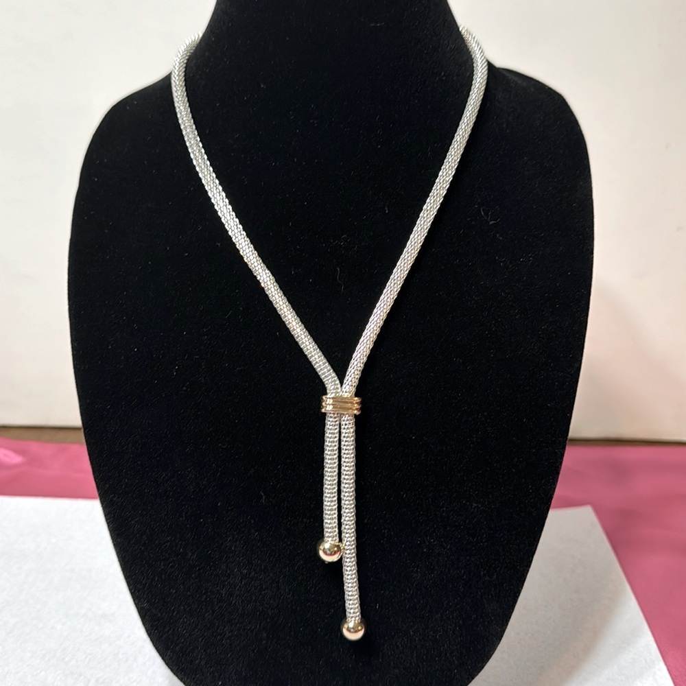 Used silver necklace with gold accents. Good condition.